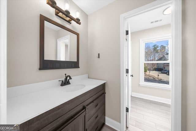 bathroom with hardwood / wood-style floors and vanity