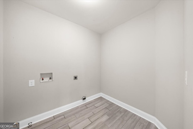 clothes washing area featuring washer hookup, light wood-type flooring, and electric dryer hookup