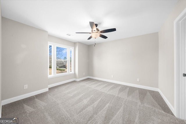 unfurnished room with ceiling fan and light colored carpet