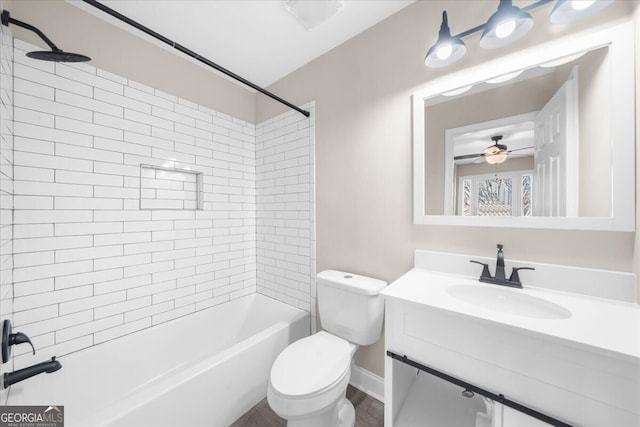 full bathroom featuring ceiling fan, toilet, tiled shower / bath, and vanity