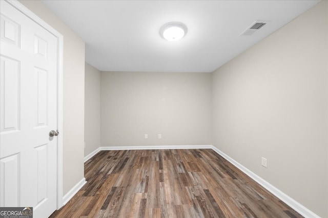 spare room featuring dark hardwood / wood-style floors