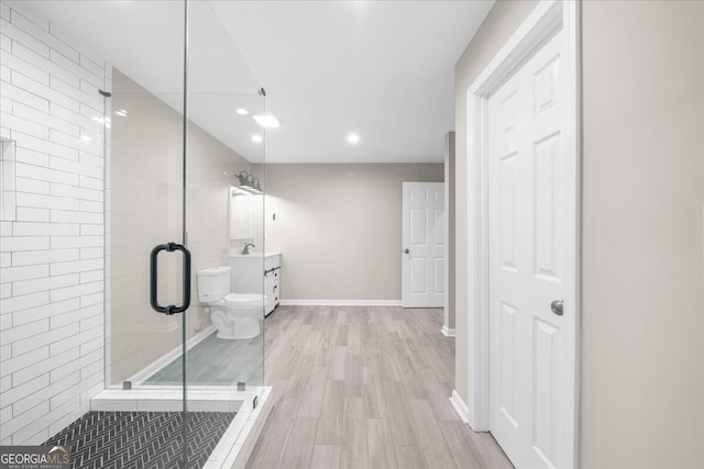 bathroom with vanity, wood-type flooring, an enclosed shower, and toilet