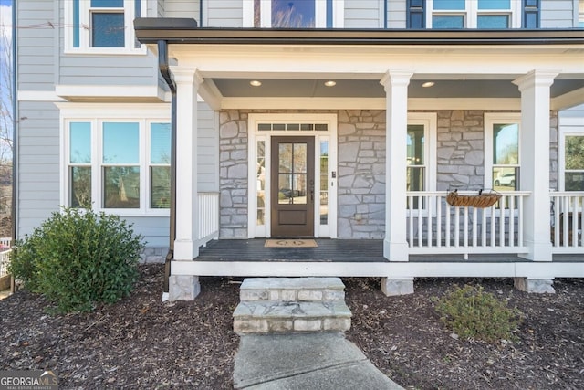 view of exterior entry with covered porch