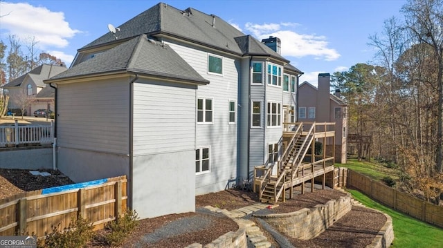 back of house featuring a wooden deck