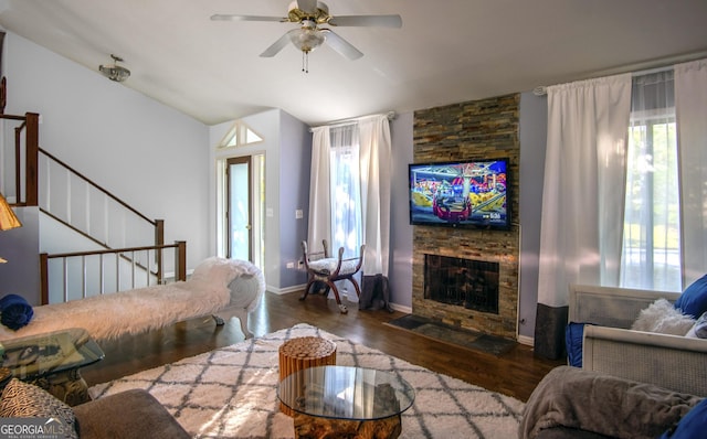 living room featuring a fireplace, dark hardwood / wood-style flooring, ceiling fan, and lofted ceiling