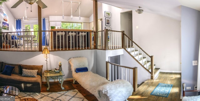 sitting room with ceiling fan, hardwood / wood-style floors, and vaulted ceiling