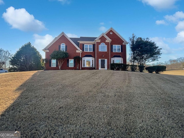 view of property featuring a front lawn