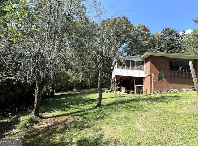 view of yard featuring a sunroom