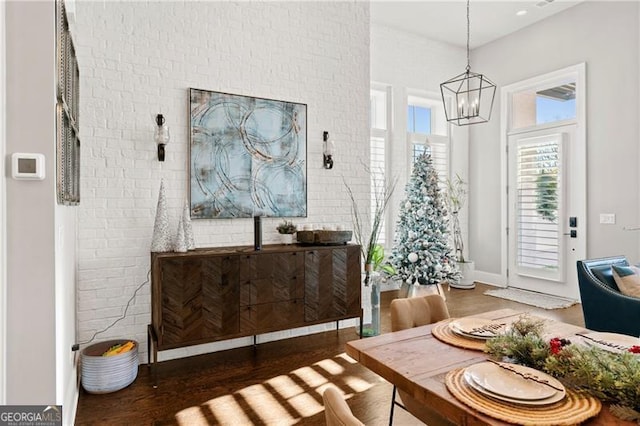 dining space with a notable chandelier and dark wood-type flooring