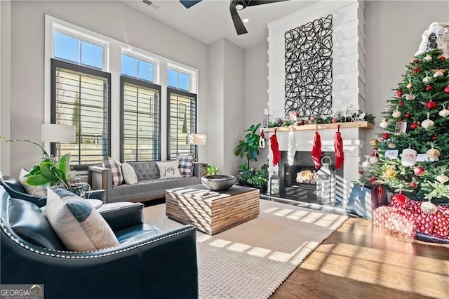 living room featuring hardwood / wood-style flooring and ceiling fan