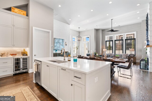 kitchen with white cabinets, sink, ceiling fan, an island with sink, and appliances with stainless steel finishes