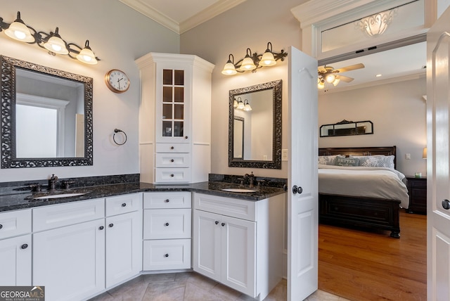 bathroom featuring ceiling fan, wood-type flooring, crown molding, and vanity