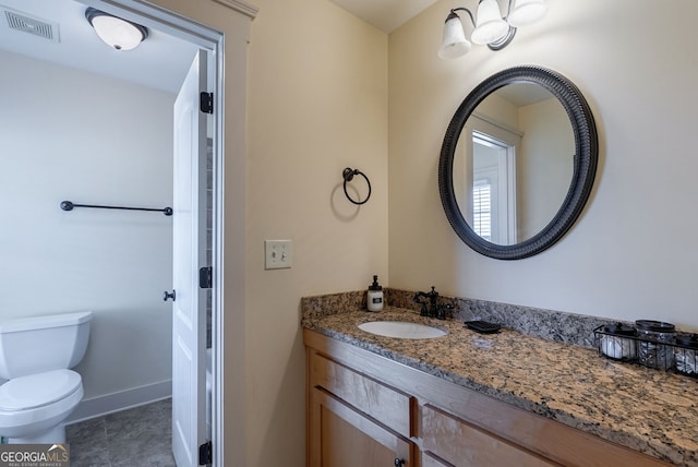 bathroom featuring tile patterned floors, vanity, and toilet