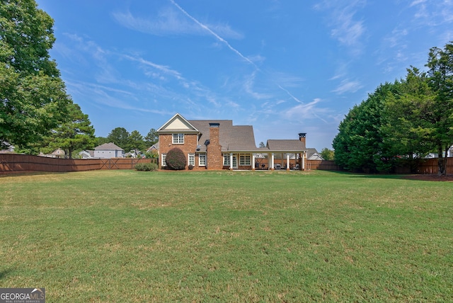 rear view of property with a yard