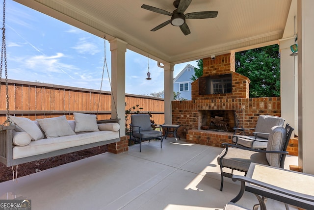 view of patio featuring an outdoor living space with a fireplace and ceiling fan