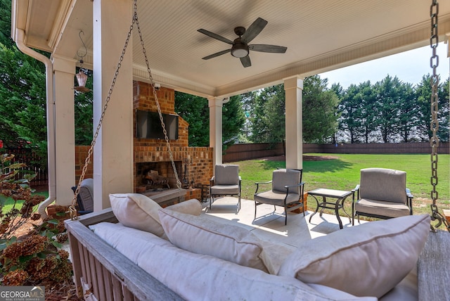 view of patio / terrace with an outdoor brick fireplace and ceiling fan