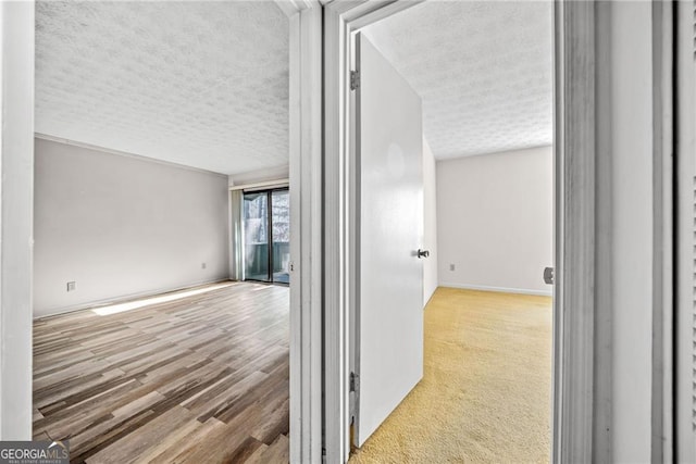 hallway featuring a textured ceiling