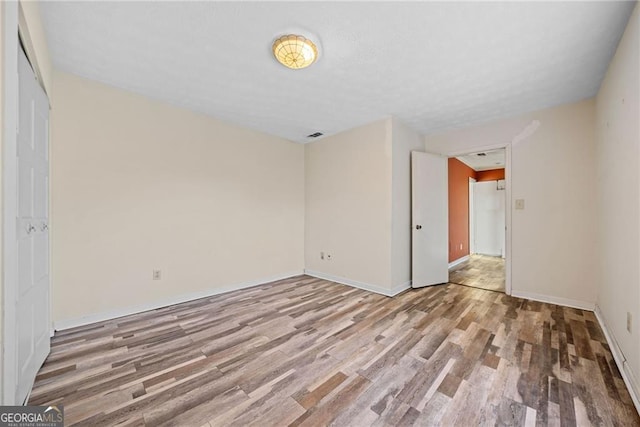 unfurnished bedroom featuring hardwood / wood-style floors