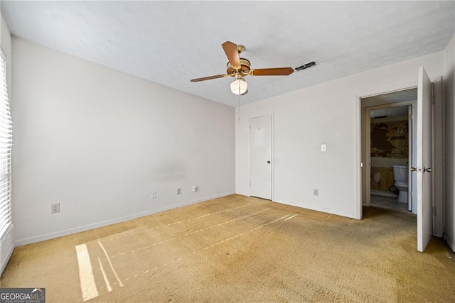 unfurnished bedroom featuring ceiling fan, carpet floors, and multiple windows