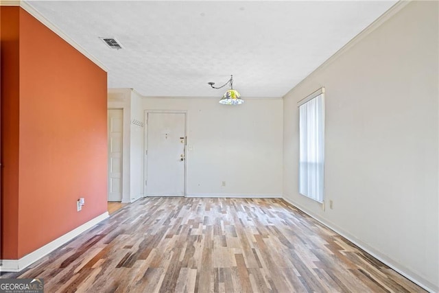 spare room with light hardwood / wood-style floors