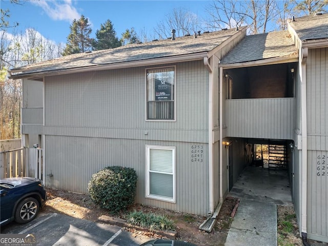 view of side of property with a carport