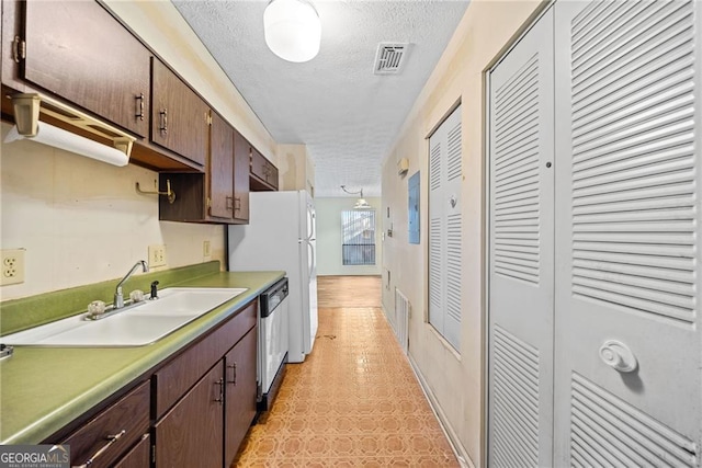 kitchen with a textured ceiling, dishwasher, sink, and dark brown cabinets