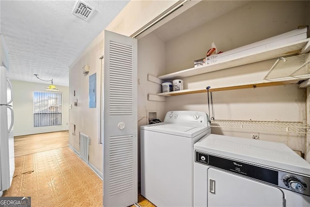 washroom featuring washing machine and dryer and electric panel