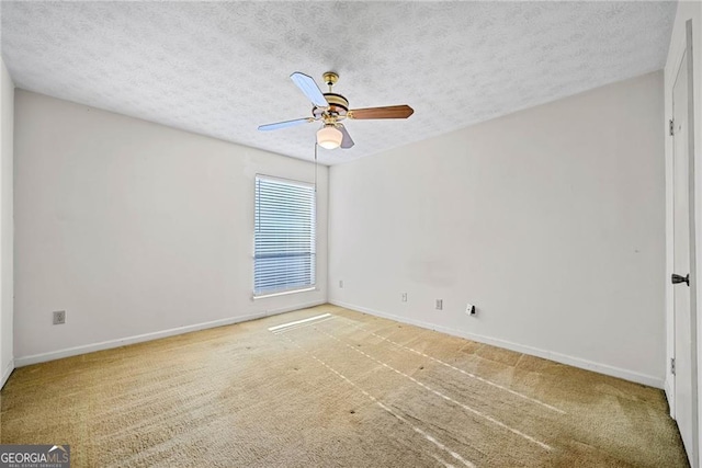 spare room with carpet flooring, a textured ceiling, and ceiling fan