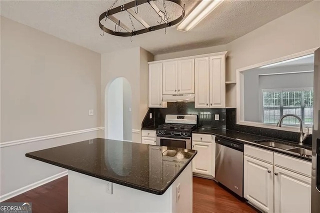 kitchen featuring a center island, white cabinetry, sink, and appliances with stainless steel finishes