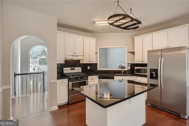 kitchen with white cabinetry, sink, a kitchen island, and stainless steel appliances