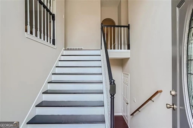 stairway featuring a high ceiling