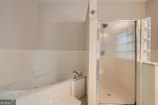 bathroom with lofted ceiling and shower with separate bathtub