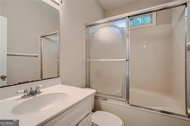 full bathroom with vanity, toilet, and combined bath / shower with glass door