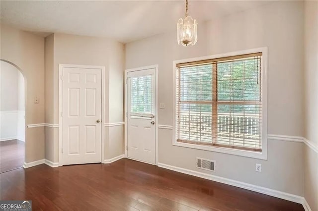 foyer featuring dark hardwood / wood-style flooring and a chandelier