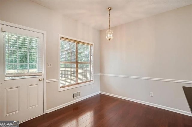 entryway featuring dark hardwood / wood-style flooring and an inviting chandelier