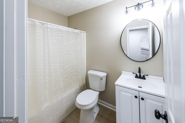 full bathroom featuring vanity, a textured ceiling, shower / bathtub combination with curtain, hardwood / wood-style floors, and toilet