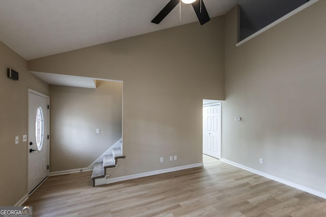 entrance foyer with ceiling fan, lofted ceiling, and light wood-type flooring