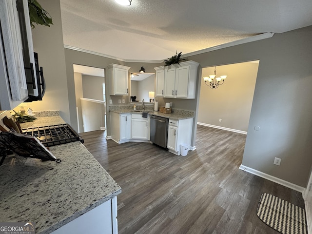 kitchen featuring pendant lighting, dishwasher, a textured ceiling, light stone counters, and white cabinetry