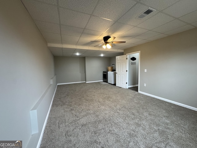 unfurnished bedroom with carpet flooring, washing machine and dryer, a paneled ceiling, and ceiling fan