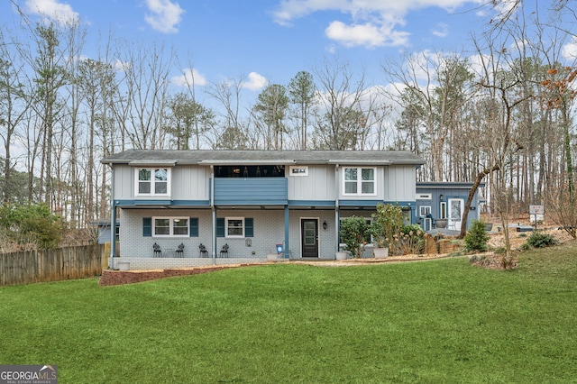 rear view of property featuring a yard