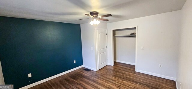 unfurnished bedroom featuring ceiling fan, a closet, and dark hardwood / wood-style flooring