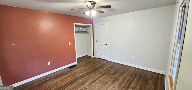 unfurnished bedroom featuring ceiling fan, a closet, and dark hardwood / wood-style flooring