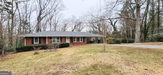 ranch-style house featuring a carport and a front lawn