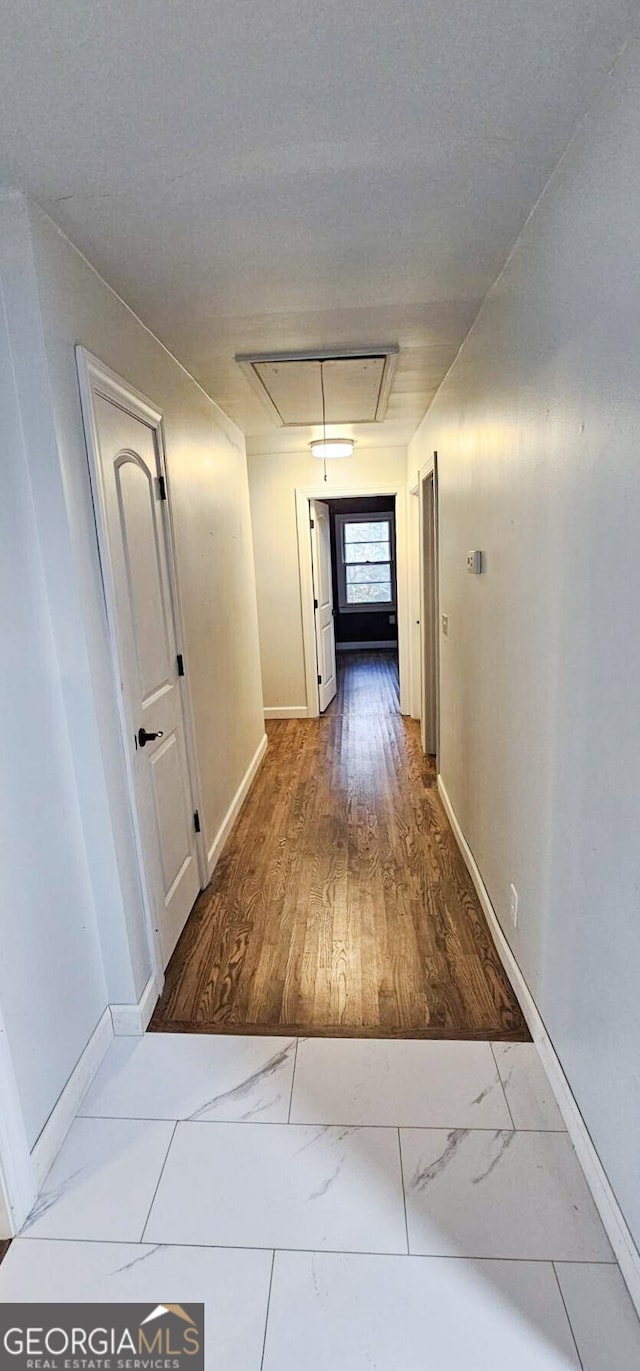 corridor with wood-type flooring