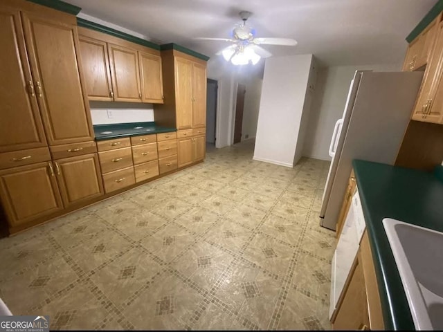 kitchen with ceiling fan, refrigerator, and sink