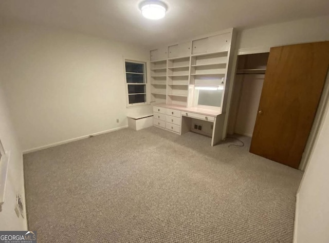 unfurnished bedroom featuring light colored carpet and a closet