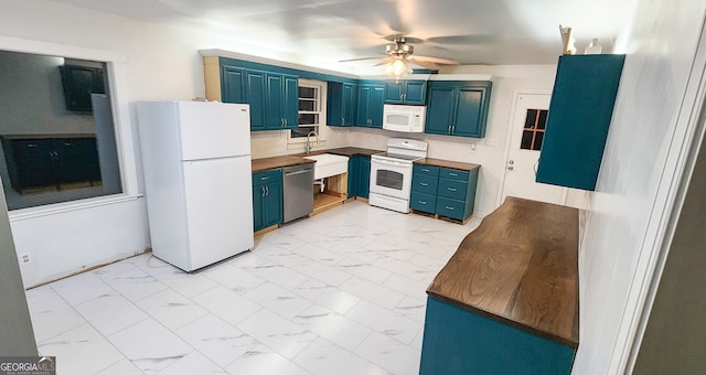 kitchen with ceiling fan, white appliances, blue cabinets, and sink