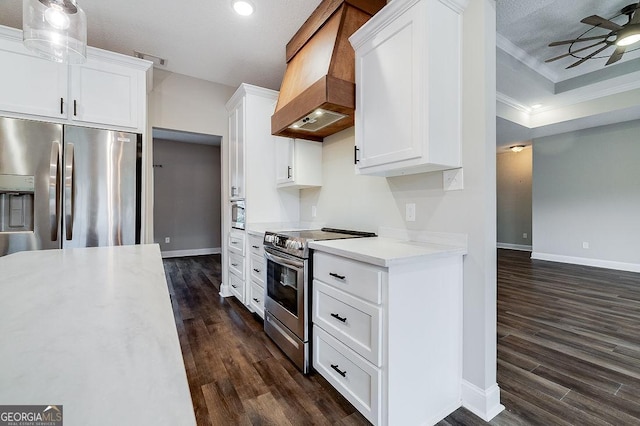 kitchen with custom range hood, a textured ceiling, stainless steel appliances, and white cabinetry