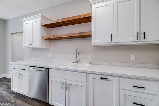 kitchen with white cabinetry, dishwasher, sink, light stone counters, and dark hardwood / wood-style flooring