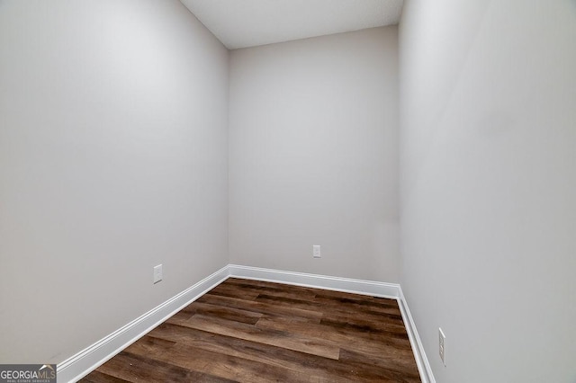 unfurnished room with dark hardwood / wood-style floors